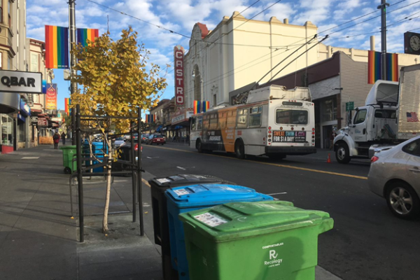 San Francisco's Castro neighborhood with the black, blue, and green waste bins in the foreground