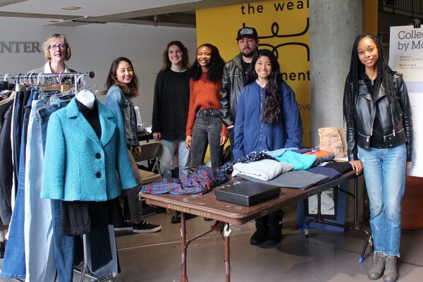 Students with the Wear Movement stand with clothes they are recycling into fashion