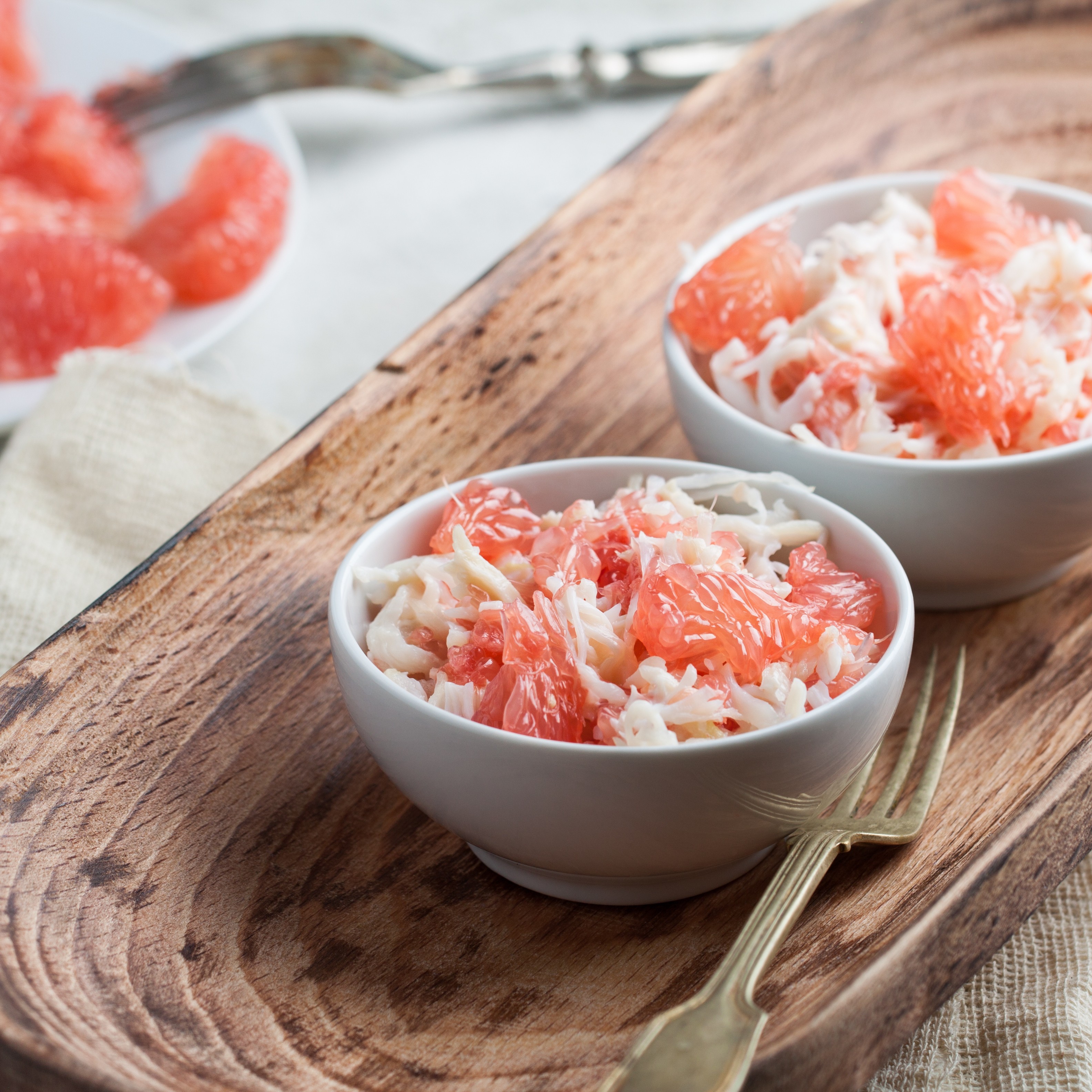 Grapefruit and shredded crab on a cutting board
