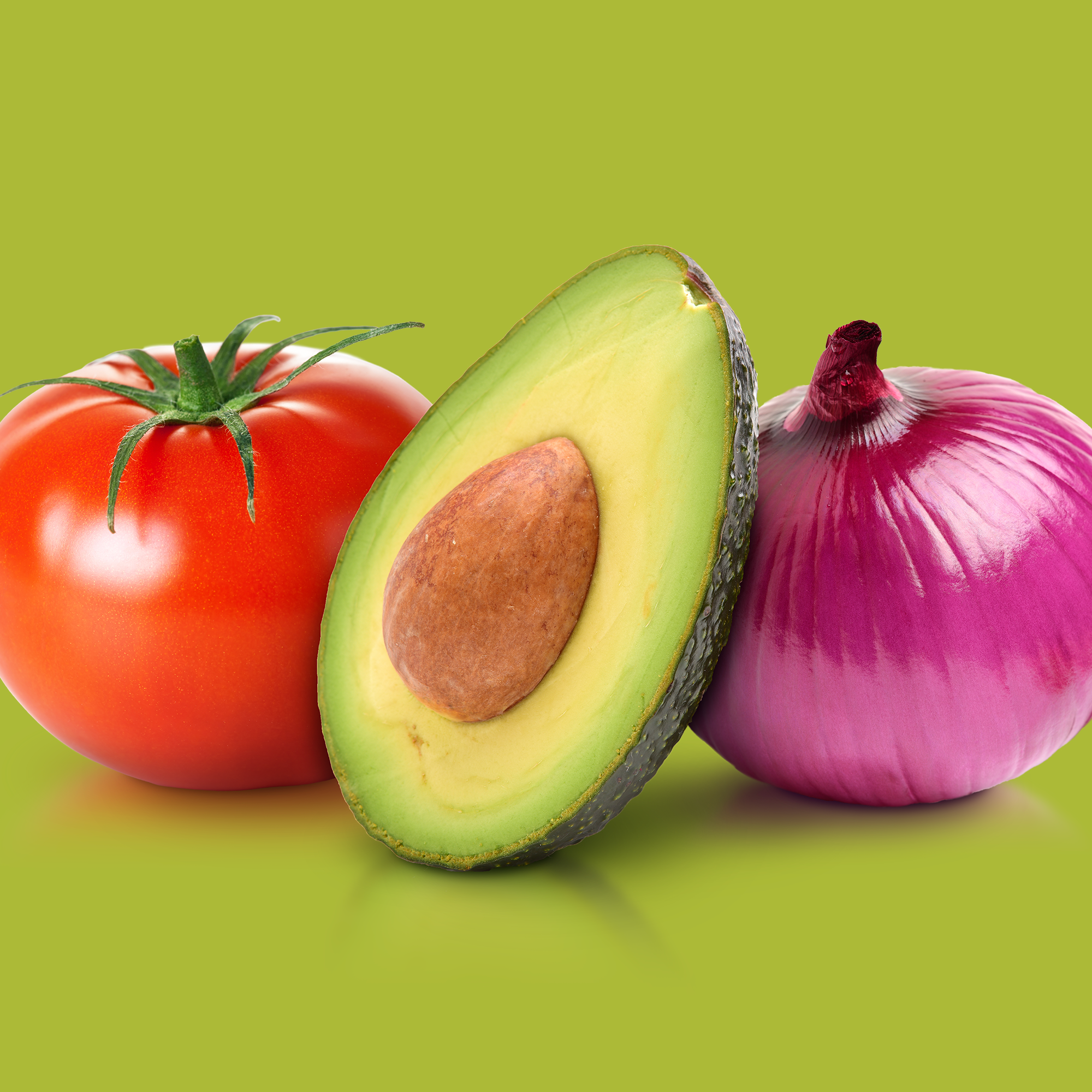 Tomato, avocado, and red onion on a green background