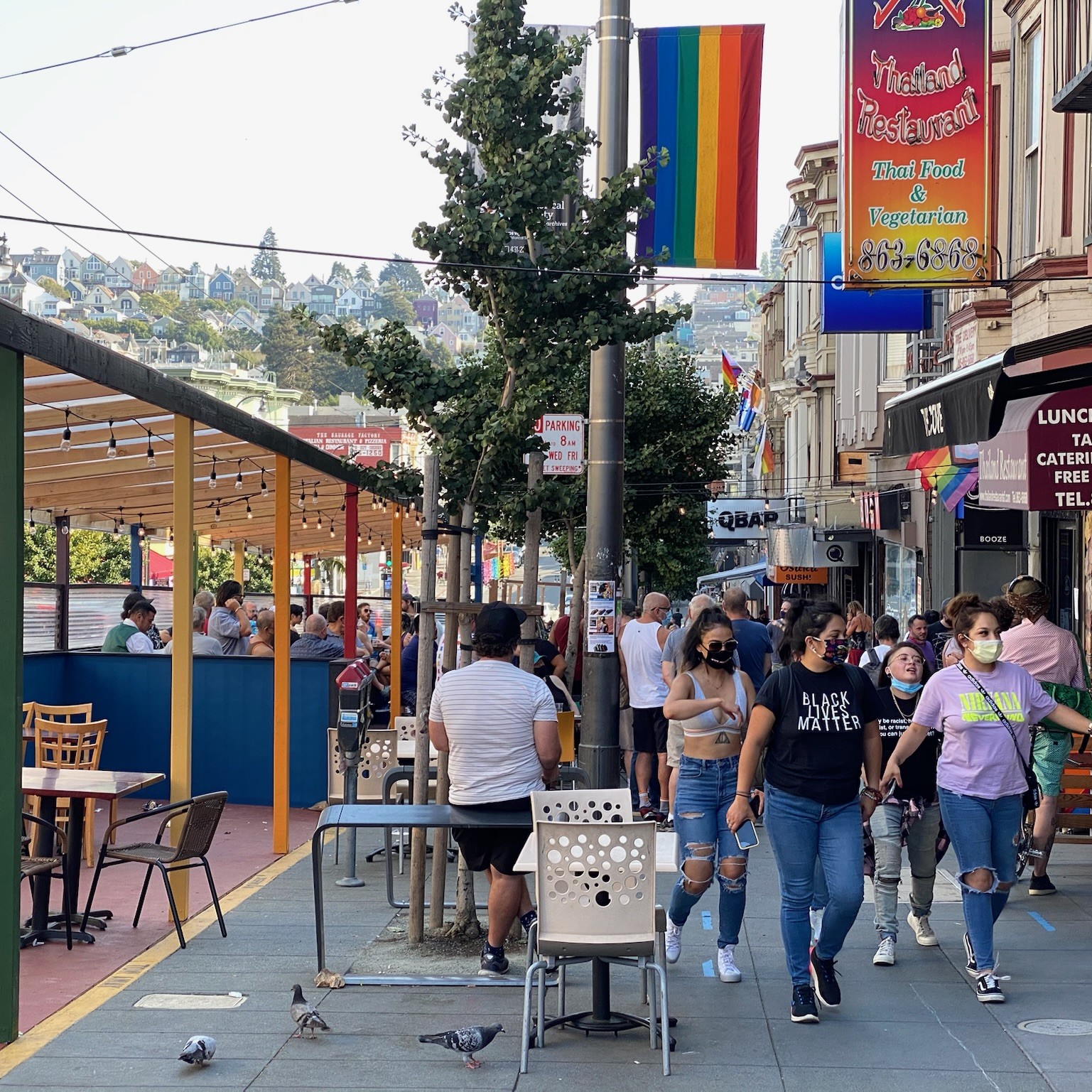 Pedestrians walk past restaurants and cafes in the Castro District of San Francisco