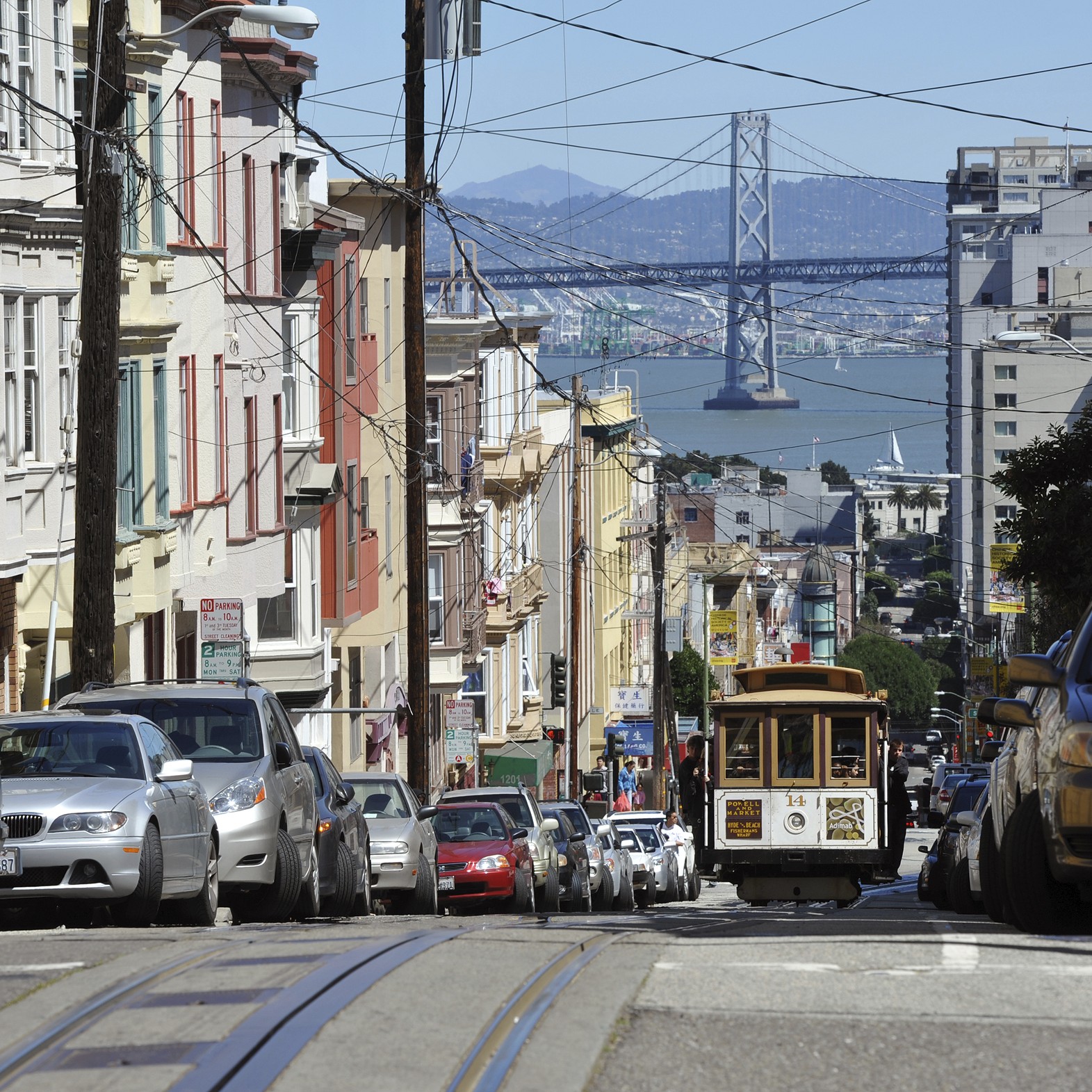 A residential street in San Francisco where the Bay Bridge can be seen in the background